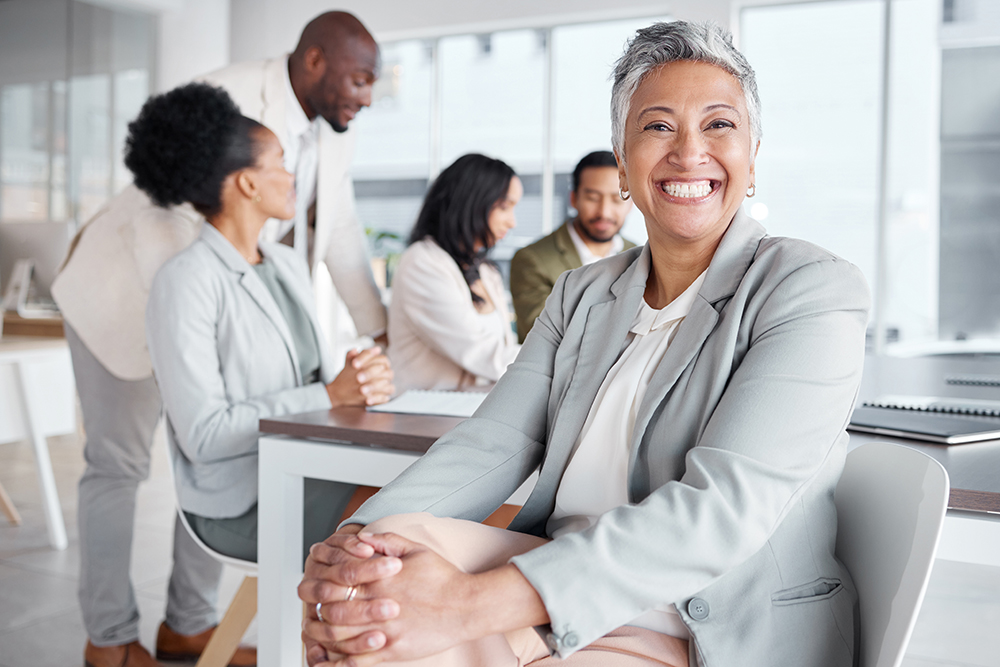 Senior female employee sitting in her work office